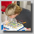 Dillon blowing out his candles on his bithday cake for his 10th birthday party at Adventure Landing.
